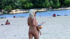 Adorable nudist teen friends enjoy sunbathing at the beach