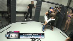 Two dudes are banging it out in the cage with the winner getting pussy