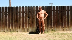 A daddy parading around naked in his backyard.